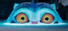 a close up of a cartoon cat 's face with big yellow eyes