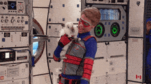 a man in a superhero costume is holding a white cat in his arms .