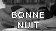 a black and white photo of a woman sleeping with the words bonne nuit written above her