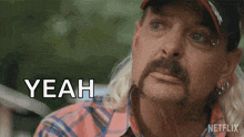 a man with a mullet and a hat is saying the word yeah