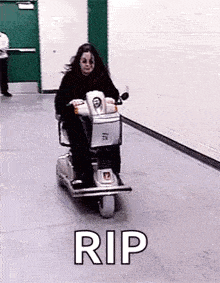 a woman is riding a scooter down a hallway with the words `` rip '' above her .