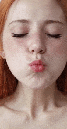a close up of a woman 's face with her eyes closed