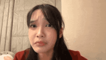 a close up of a woman making a funny face while looking at the camera .