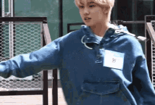a young man wearing a blue hoodie has a name tag that says " won "