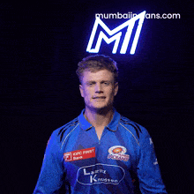 a man wearing a blue shirt that says indians