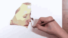 a person is drawing a woman with a pencil on a piece of paper
