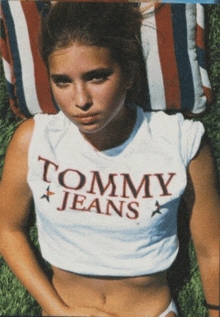 a woman wearing a white tommy jeans t-shirt