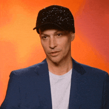 a man wearing a hat and a blue jacket