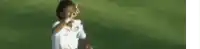 a blurry picture of a soccer player wearing a white shirt with the number 10 on it