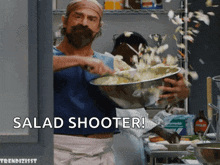 a man holding a bowl of food with the words salad shooter written on the bottom