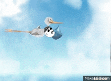 a stork is carrying a baby in a blue blanket ..