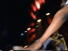 a blurry picture of a person 's hand holding a bottle