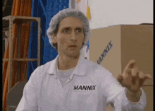 a man wearing a white lab coat with the word mannix on the front