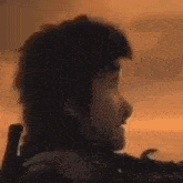a man in a wheelchair is holding a sword in his hand .