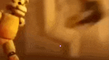 a yellow teddy bear is standing in front of a wall in a dark room .
