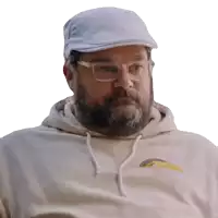 a man with a beard and glasses wearing a white hat