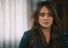 a woman in a leather jacket is making a funny face