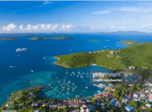 an aerial view of the islands of the british virgin islands with a cruise ship in the distance .