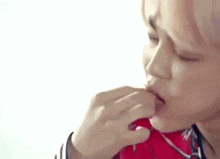 a close up of a person eating a candy with their hand .