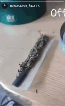 a picture of a cigarette being rolled on a table with a caption that says off