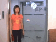 a girl wearing an orange shirt that says little park sunshine