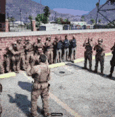 a group of soldiers are standing in a parking lot