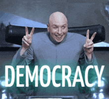 a bald man is giving a peace sign in front of a sign that says democracy