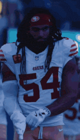 a man wearing a 49ers jersey with the number 54 on the front