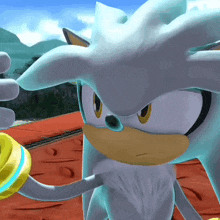 a close up of a sonic the hedgehog holding a yellow ring