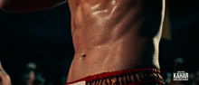 a close up of a man 's torso with the word kahar on it