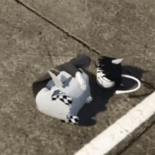 a white unicorn statue is laying on the ground next to a white line .