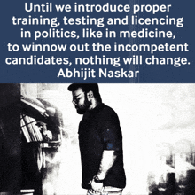 a man stands in front of a sign that says until we introduce proper training testing and licensing in politics