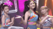a group of young women are dancing on a stage with the words simply pro on the bottom right