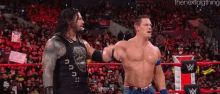 Roman Reigns John Cena GIF - Roman Reigns John Cena Raises Hand GIFs