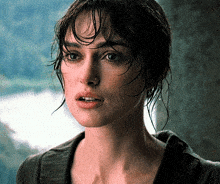 a close up of a woman 's face with water on her hair