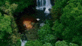 an aerial view of a waterfall in the mountains