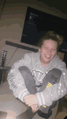 a woman wearing a grey sweatshirt with the word always on it