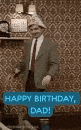 a man in a suit and tie is dancing in a living room .