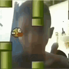 a man is playing a video game with a bird on his head