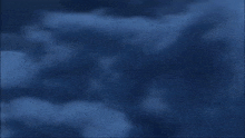 a plane is flying through a cloudy sky