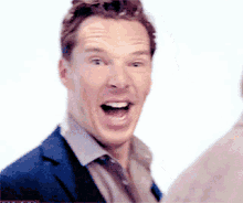 a man in a suit and tie is making a funny face
