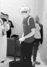 a black and white drawing of a man holding a suitcase and a backpack .