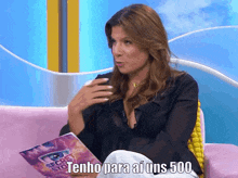 a woman is sitting on a pink couch holding a book titled secret stories