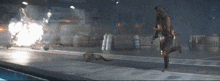a woman running with a gun in a dark room with a sign that says ace