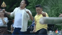 a group of men are dancing in front of a drum set with the number 7 in the corner