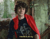 a man wearing a red cape and a wolf t-shirt says i felt like it it 's my
