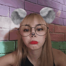 a woman wearing glasses and a koala mask