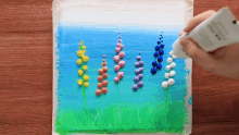 a painting of flowers with a tube of glue