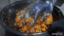 rice is being stirred in a pan that says made in animonica