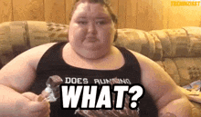 a very fat woman is sitting on a couch eating chips and asking what ?